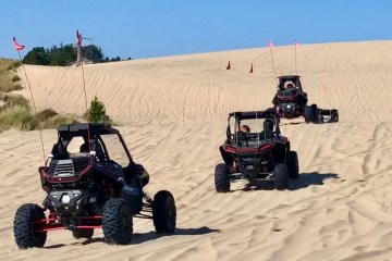 off-road vehicles going up sand dunes